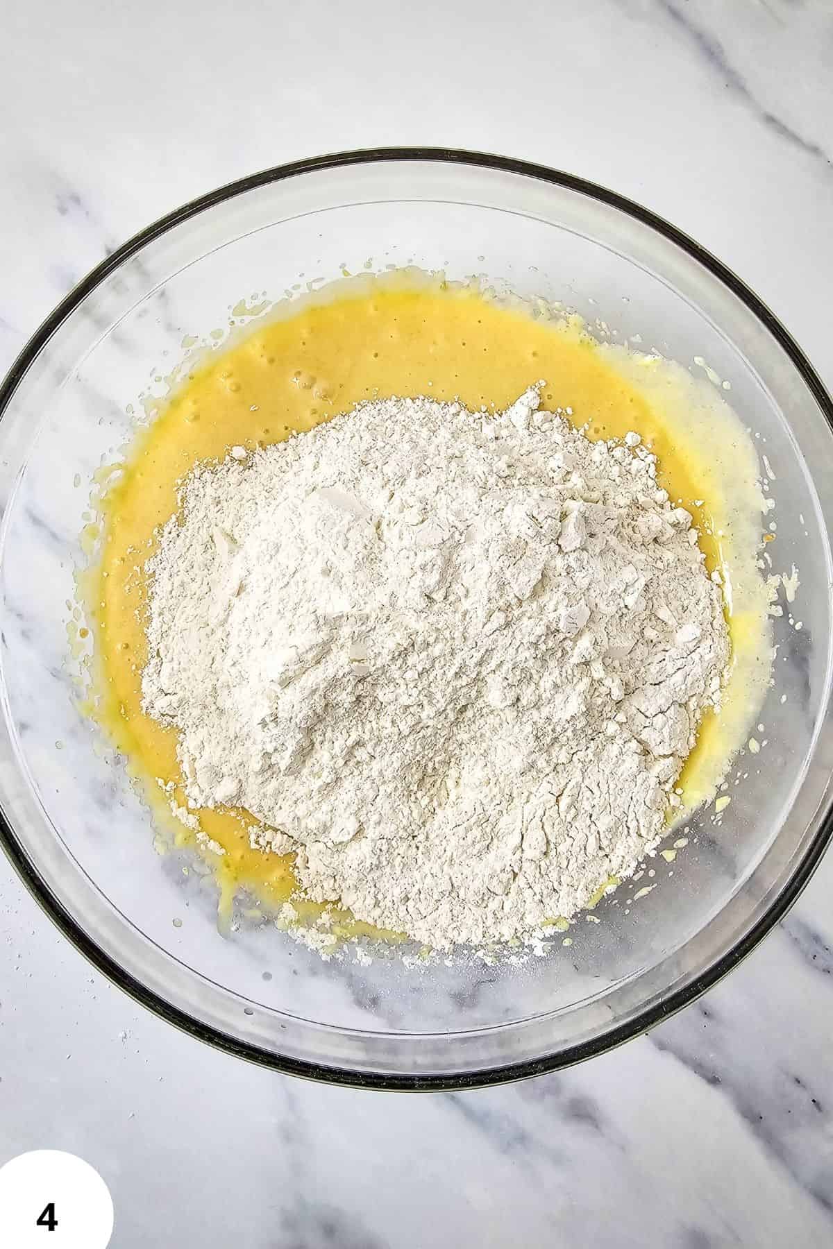 Preparing muffin batter with flour and butter for blackberry muffins.