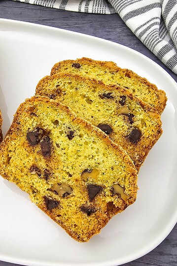 Chocolate chip zucchini bread slices on a white plate.