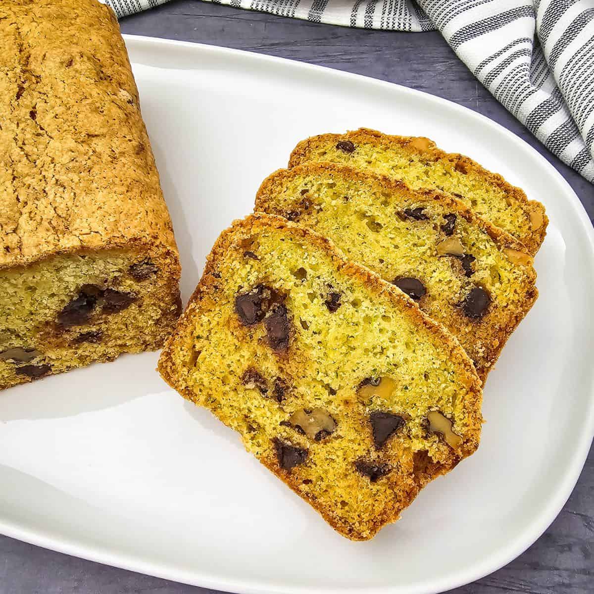 Chocolate chip zucchini bread slices on a white plate.