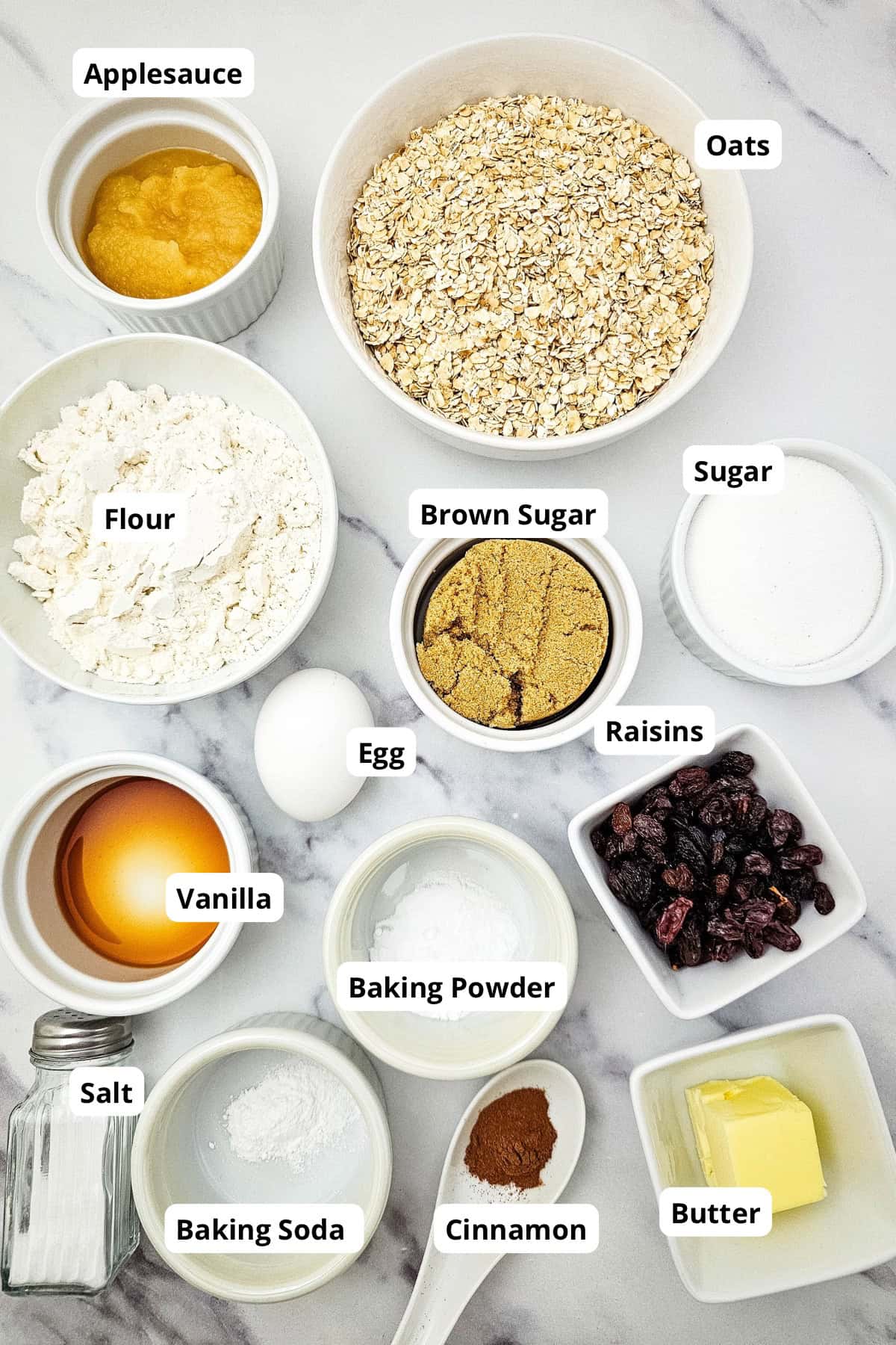 Ingredients for oatmeal raisin cookies including oats, raisins, flour, and spices.