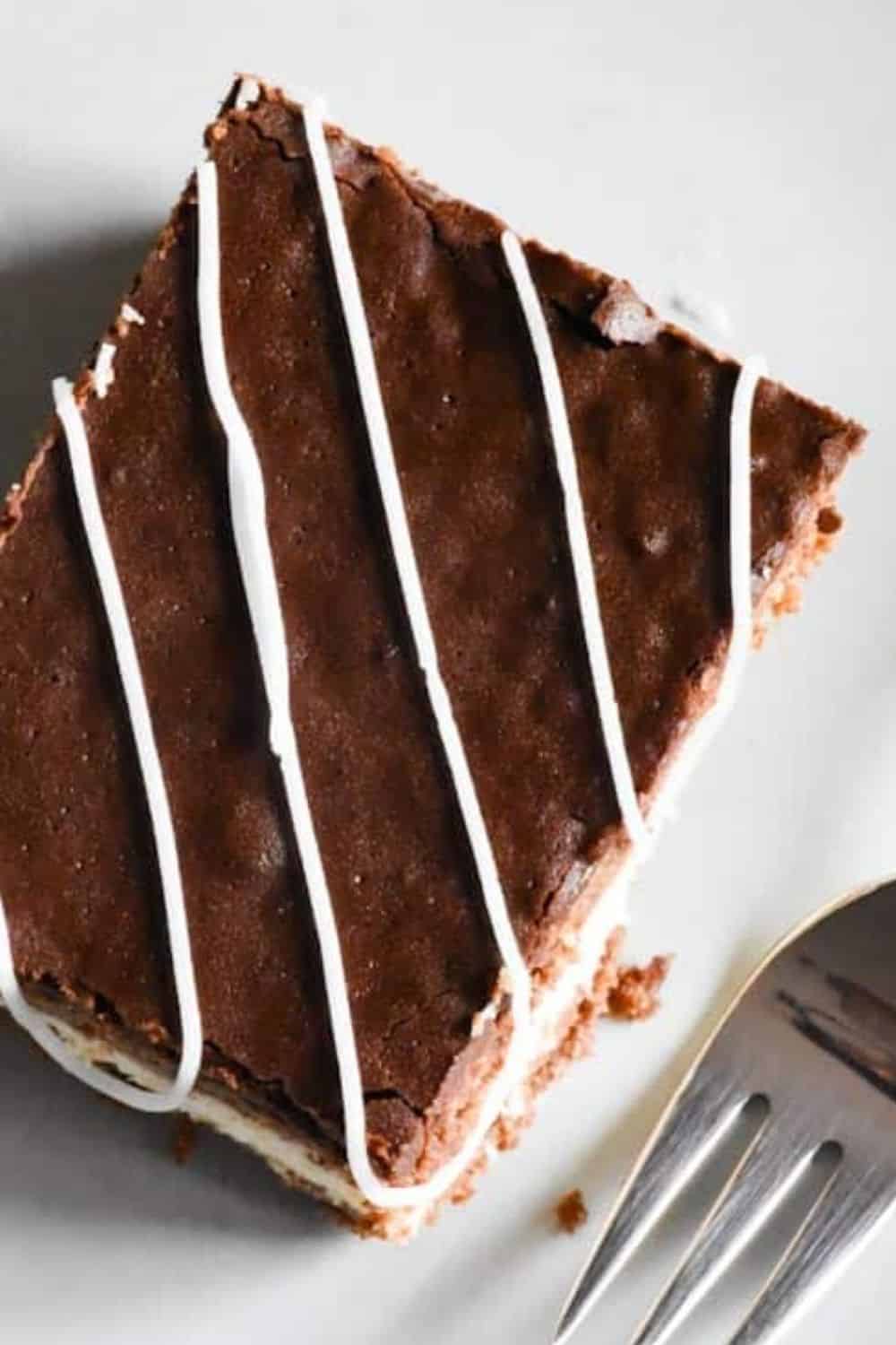 Chocolate cake slice with white icing drizzle, perfect for baking and bread making.