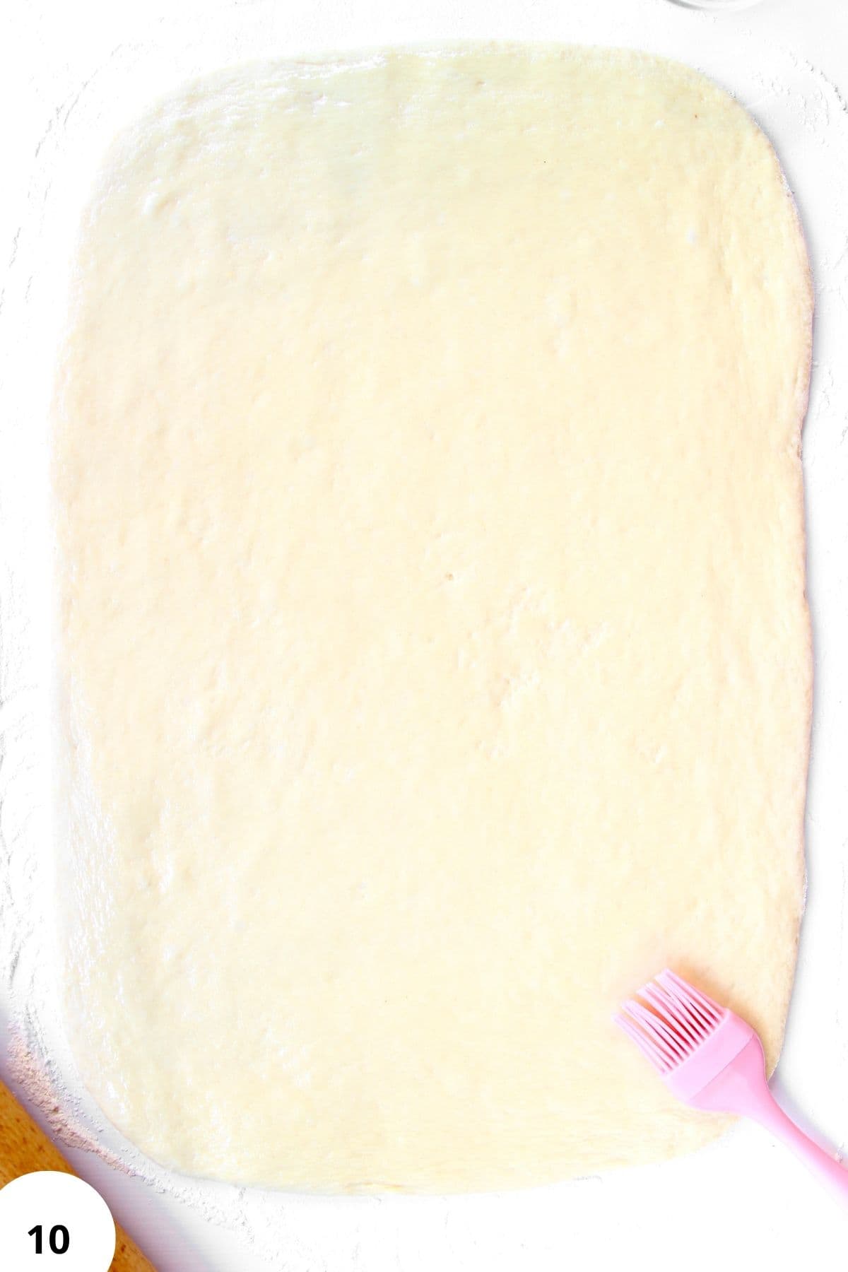 Sourdough dough being stretched and folded during bread preparation.