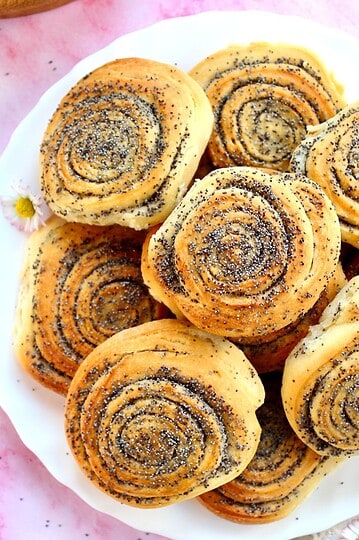 Sourdough rolls with poppy seeds, showcasing stretch and fold techniques. Perfect for baking enthusi.