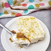 Creamy pineapple dessert with graham cracker crust and whipped topping.