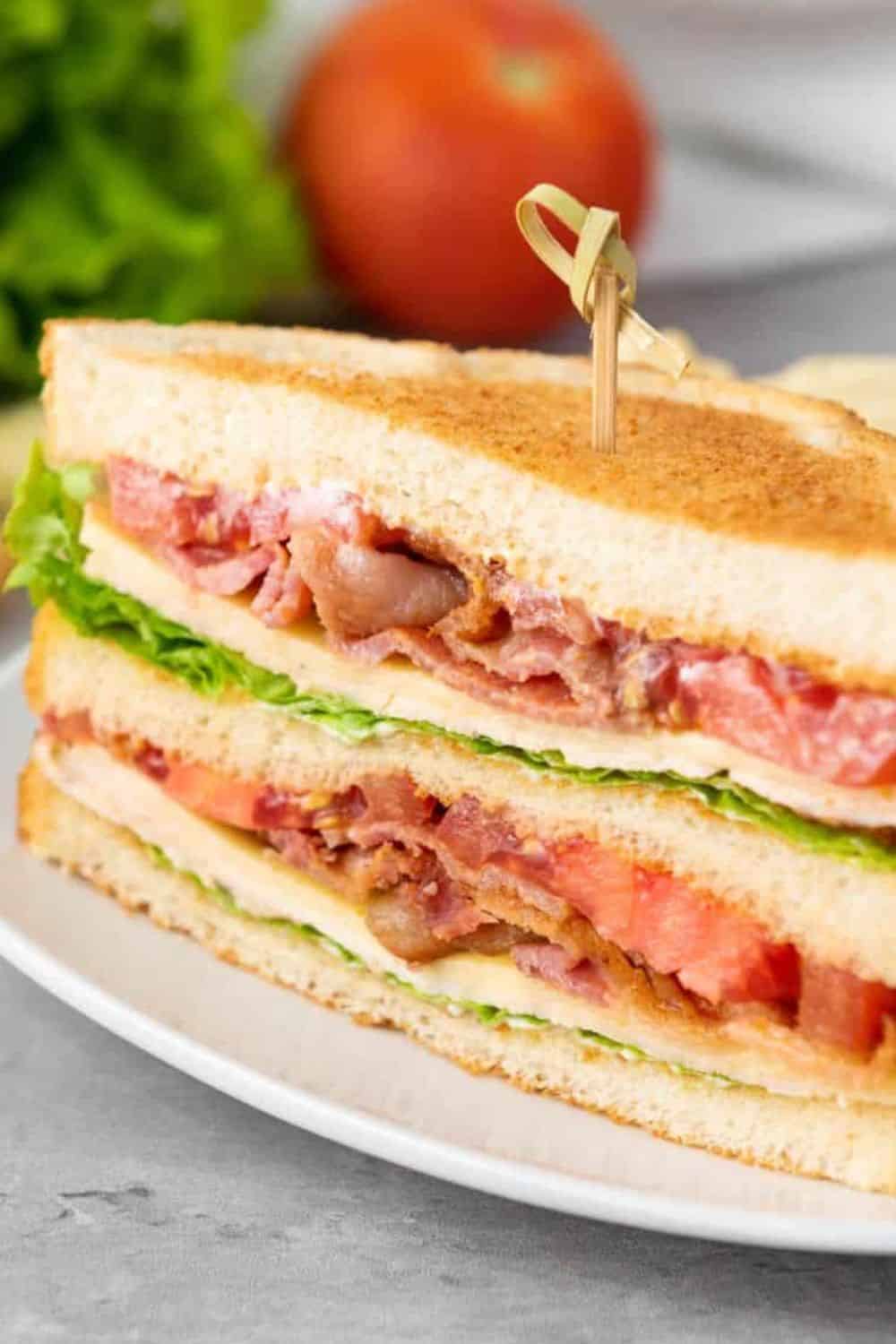 Sandwich with lettuce, tomato, and meat filling, perfect for quick meals.