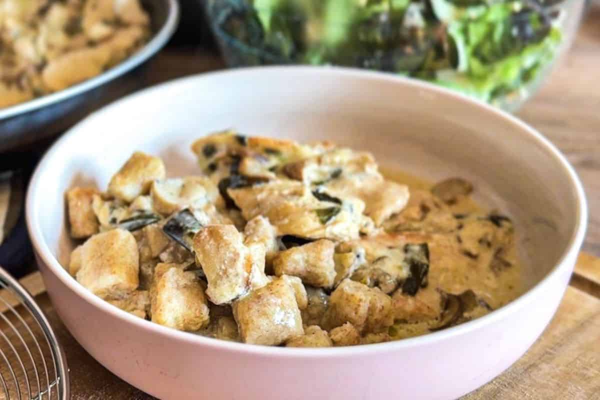 Homemade gnocchi made with fresh-milled flour served in a pink bowl.