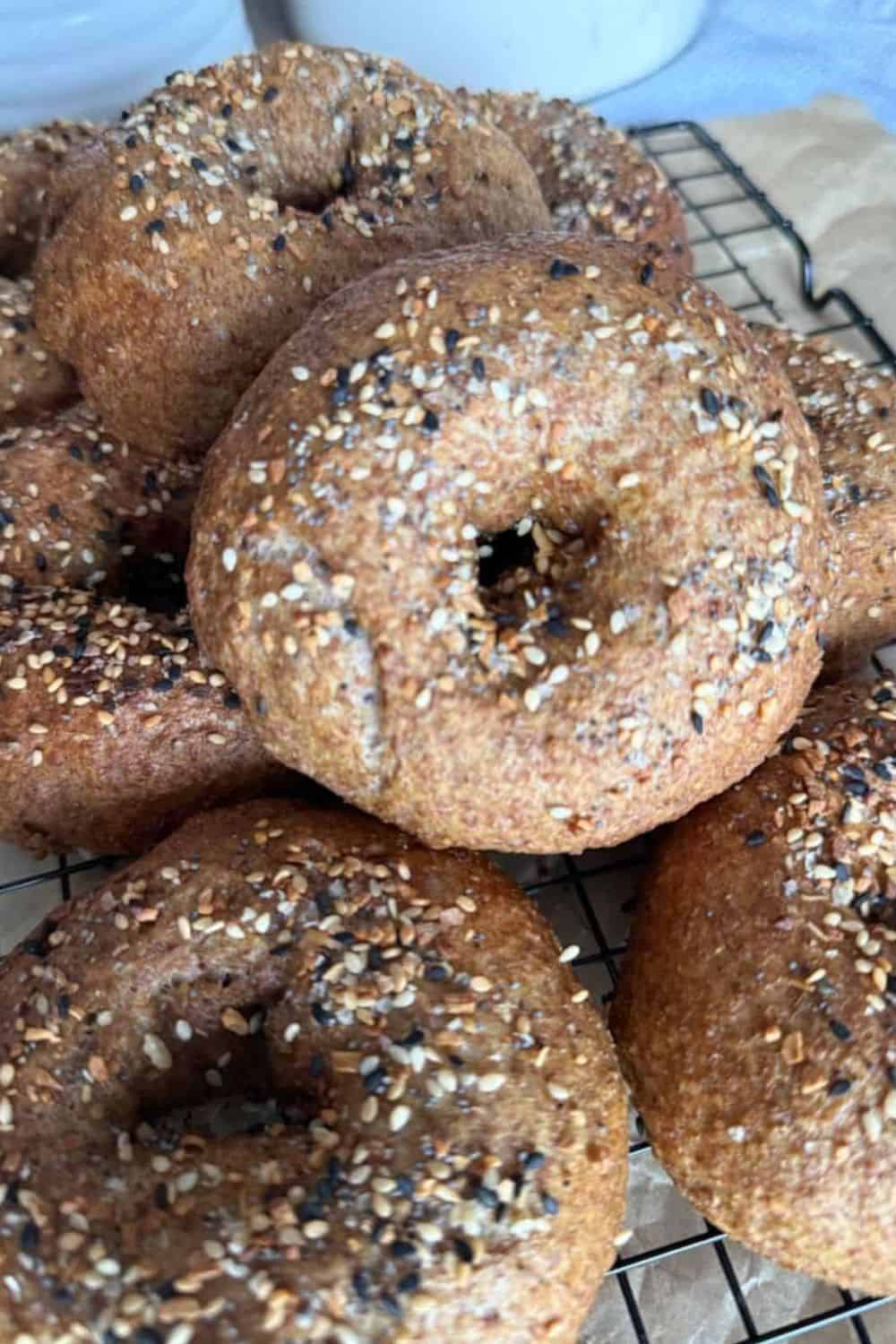 Fresh baked whole grain bagels with seeds and oats, perfect for breakfast or snacks.