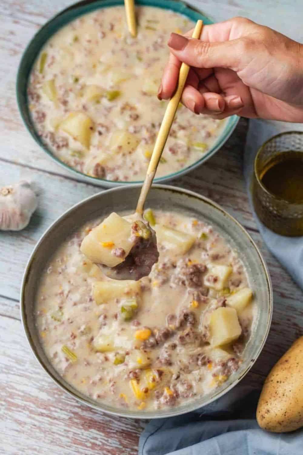 Hearty ground beef stew with potatoes and vegetables in a creamy broth.