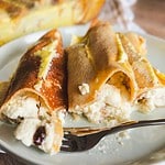 Creamy cheese-filled baked crepes with golden, crispy edges.