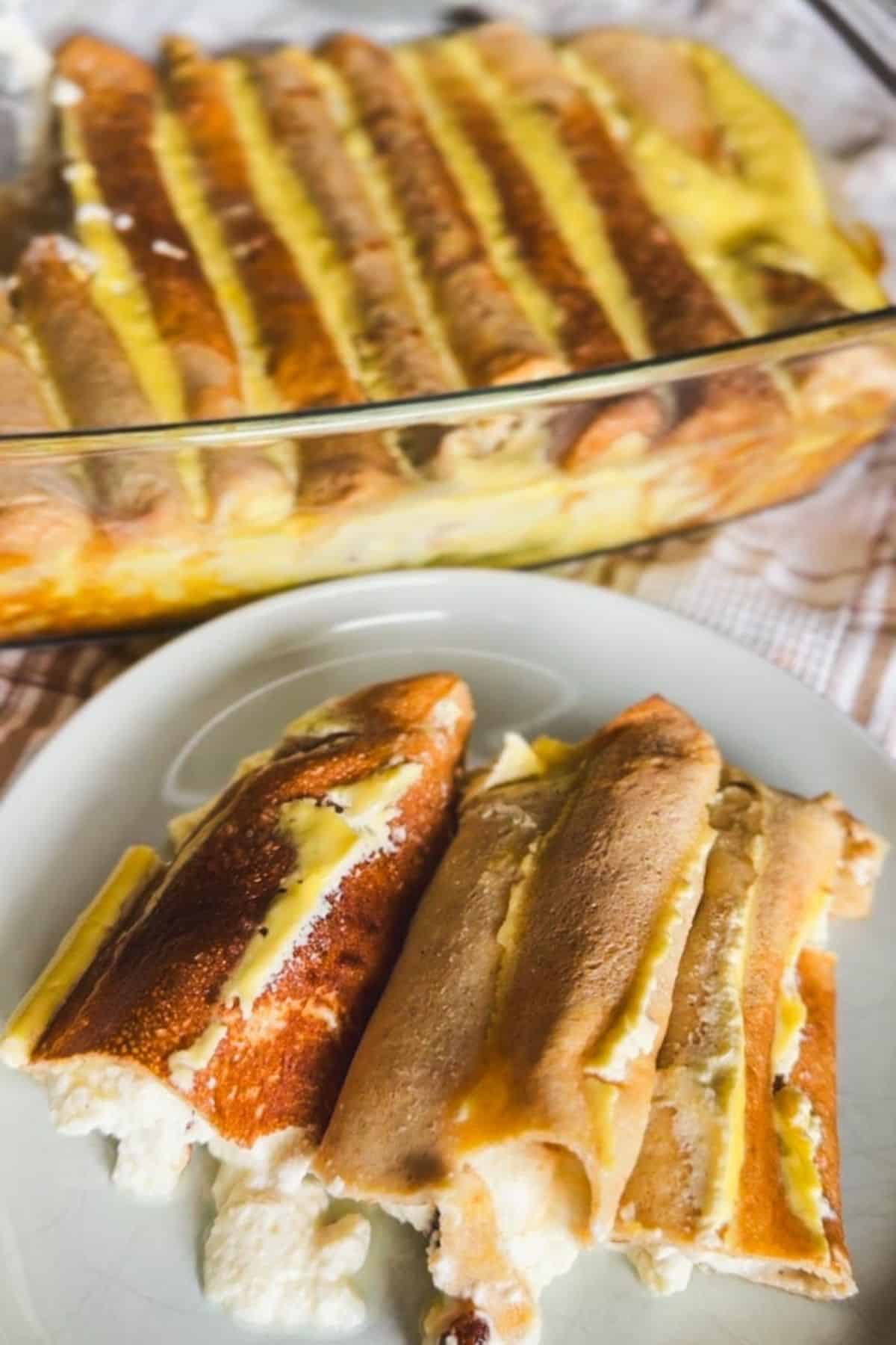 Delicious baked crepes filled with sweet cheese, showcased in a glass dish with a close-up of a crep.