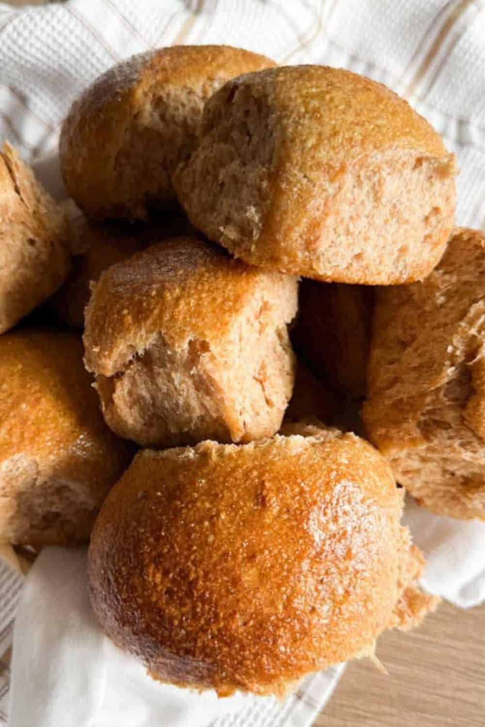 Freshly baked bread rolls with a golden crust, perfect for sandwiches or breakfast.