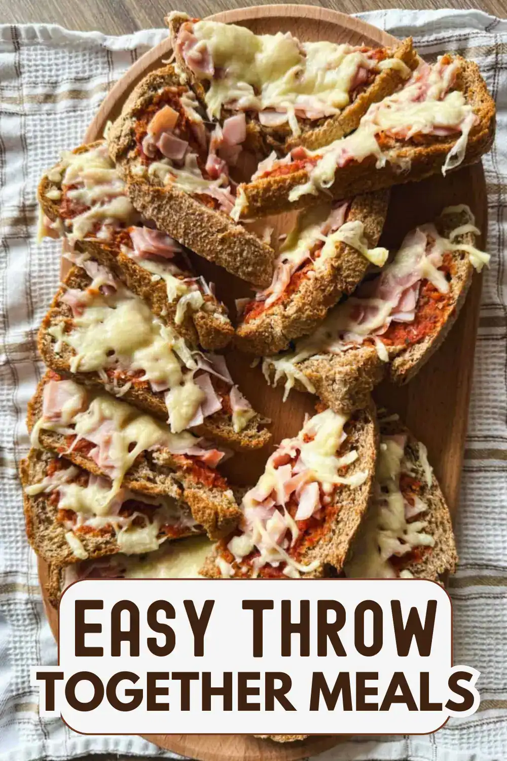 Easy throw together meals with bread, ham, and cheese on a wooden platter.