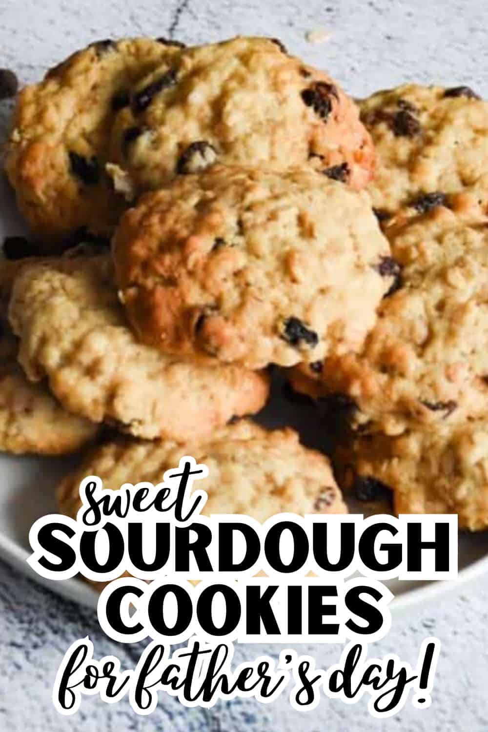 Close-up of freshly baked sourdough cookies with chocolate chips on a rustic surface.