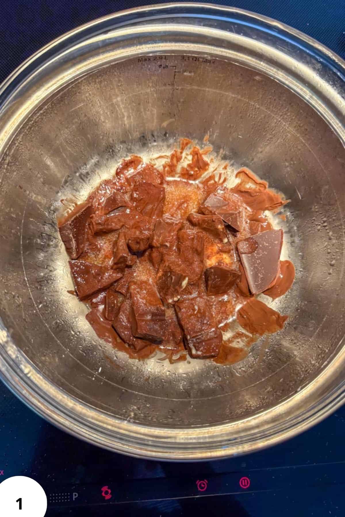 Chocolate chunks in a glass bowl, ready for bread dough folding and shaping.