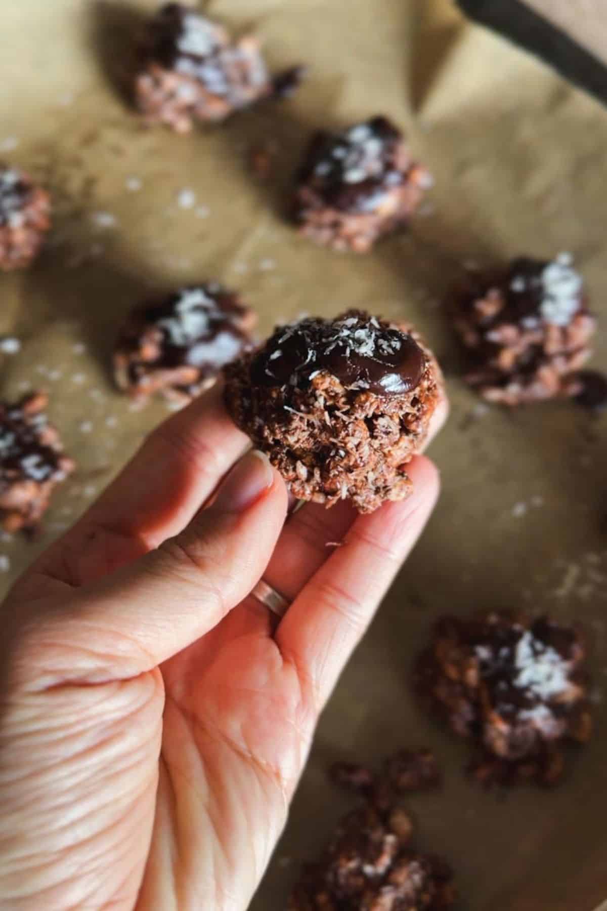 Close-up of chocolate energy bites sprinkled with sea salt on baking sheet.
