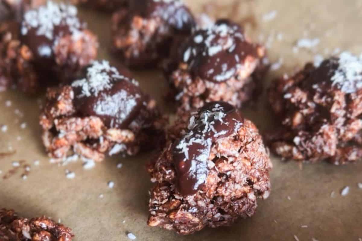 Delicious chocolate energy bites topped with shredded coconut and drizzled with chocolate.