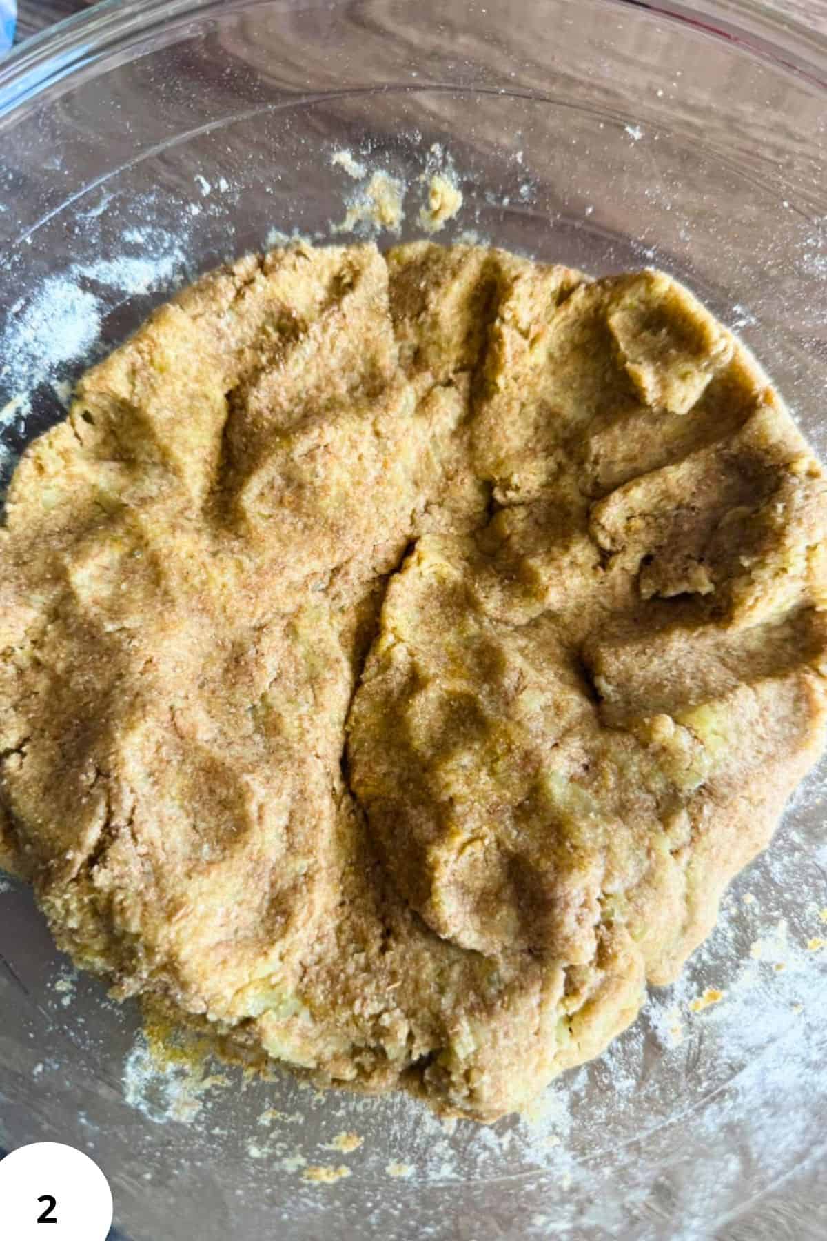 Freshly milled grain dough in a glass bowl, ready for baking or cooking.