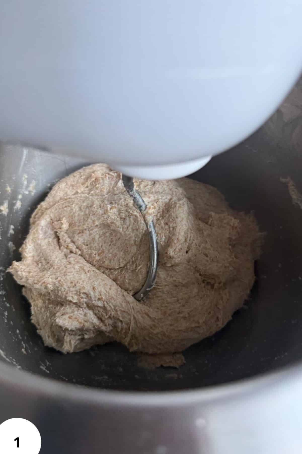Sourdough dough in a mixer with a dough hook attachment.