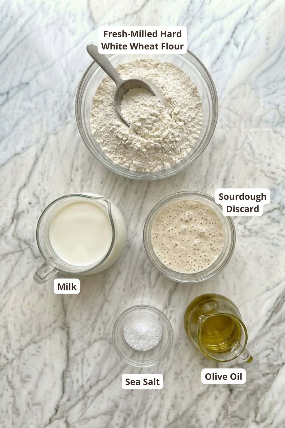 Fresh milled white wheat flour in a glass bowl with ingredients for baking.