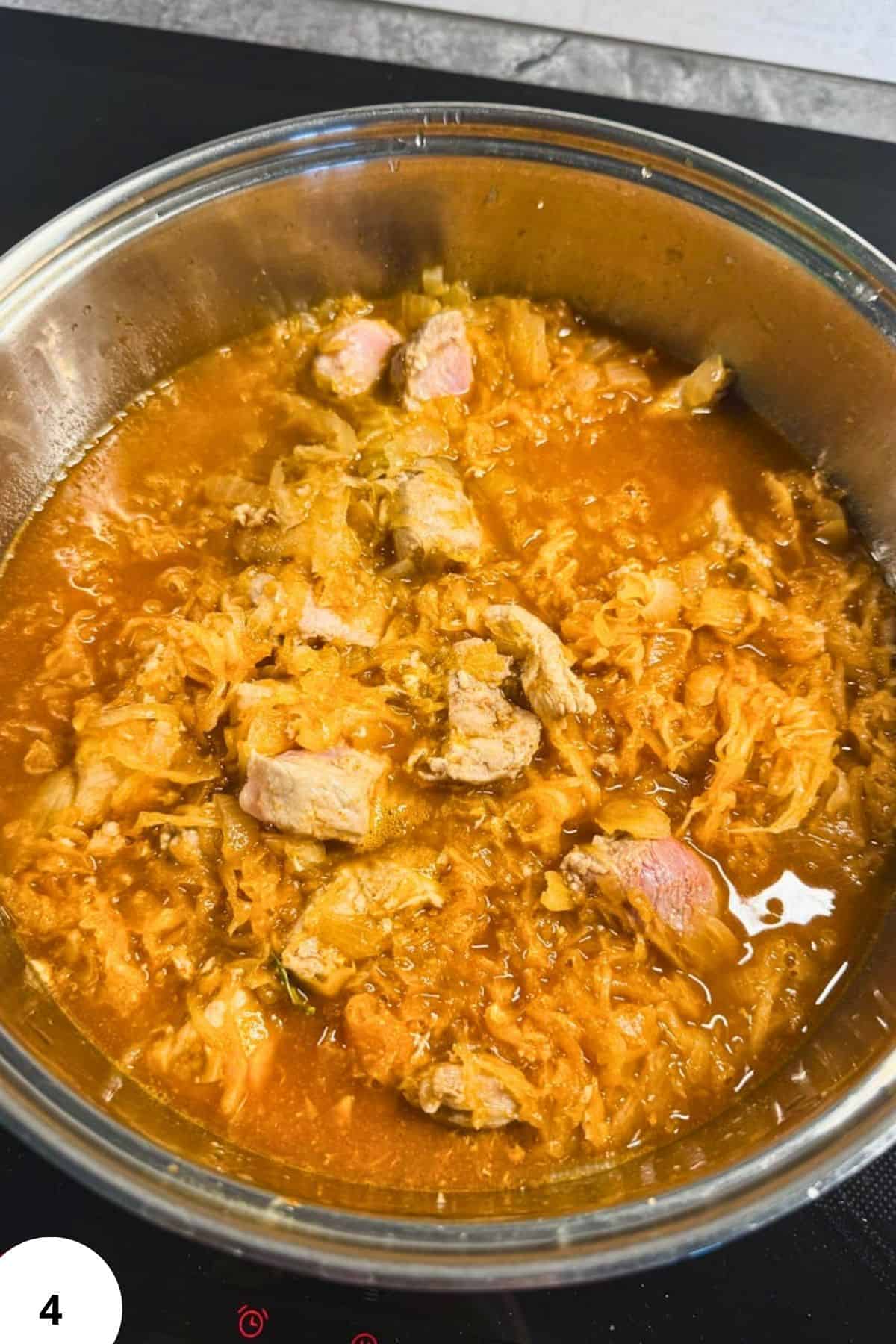 Hearty pork and sauerkraut goulash cooked in a slow cooker, perfect for comforting meals.