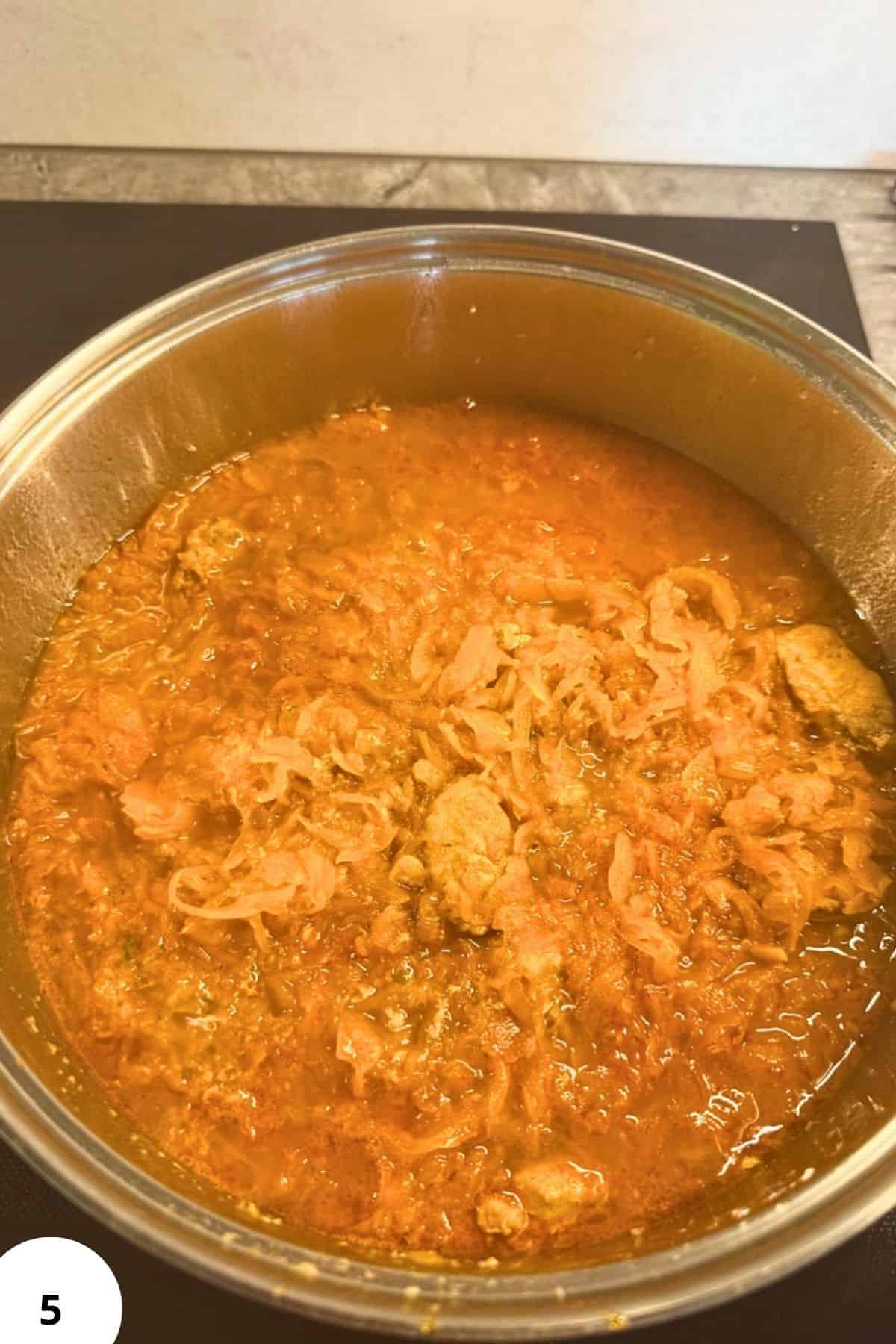 Pork and sauerkraut goulash in a pot, showcasing a hearty Hungarian dish.