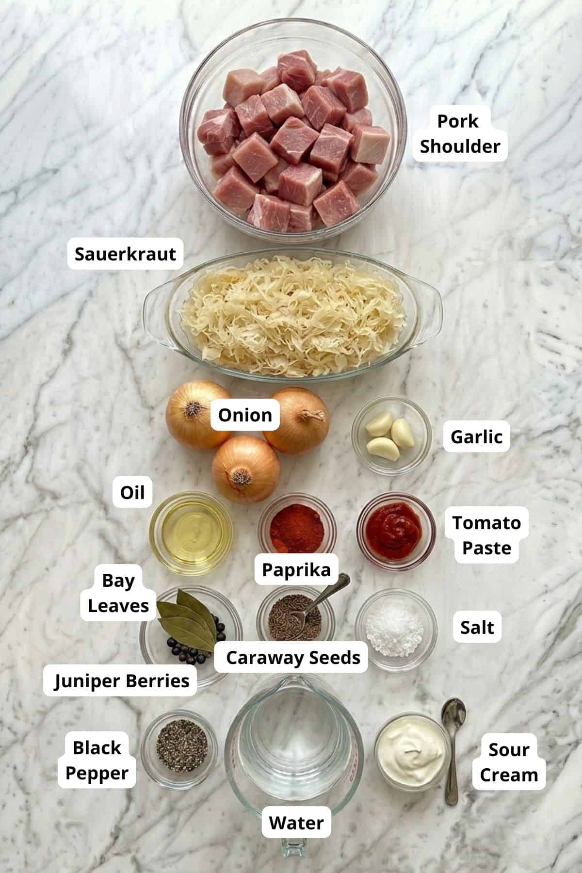 Pork shoulder, sauerkraut, onion, garlic, oil, tomato paste, bay leaves, paprika, caraway seeds, jun.