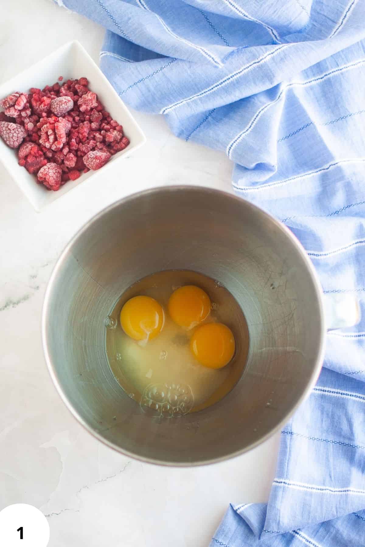 Eggs in a metal bowl ready for baking or bread making.