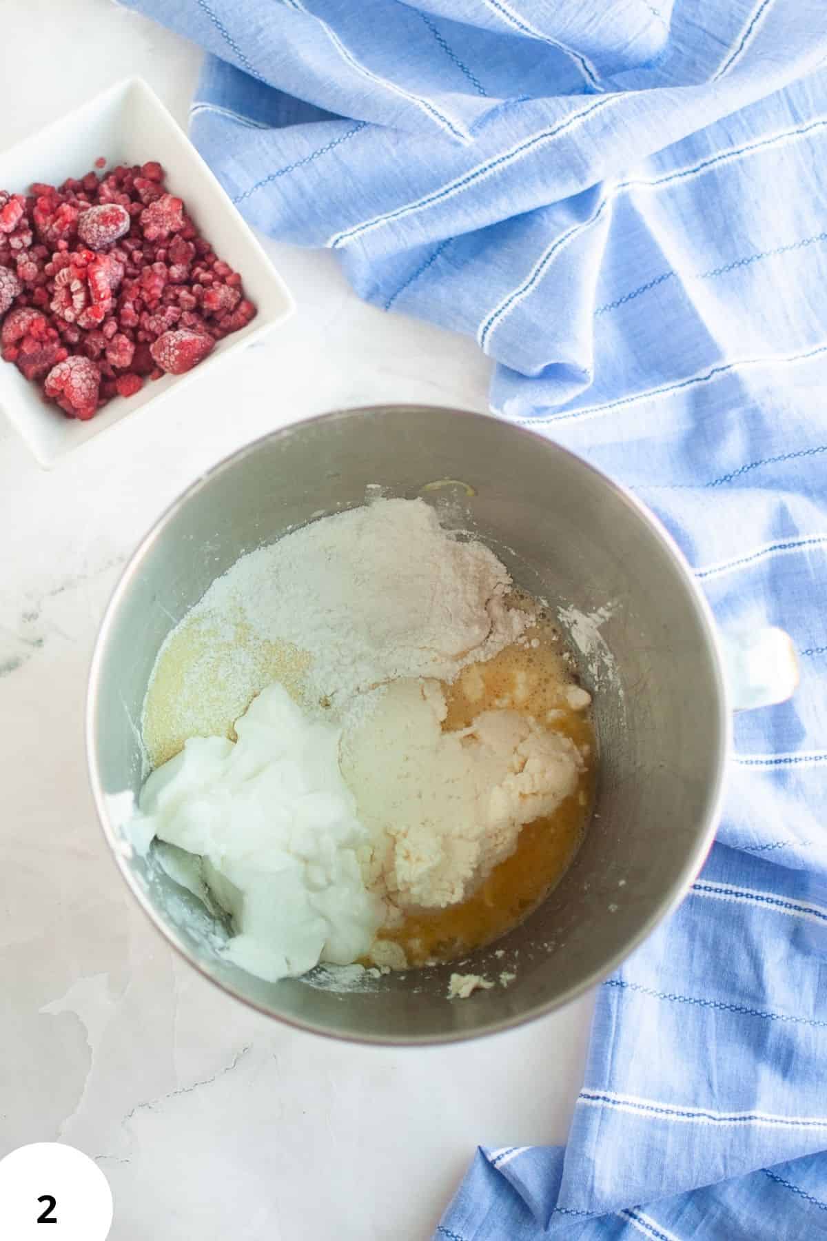 Dough mixture with flour, yogurt, and eggs in a mixing bowl for bread baking.