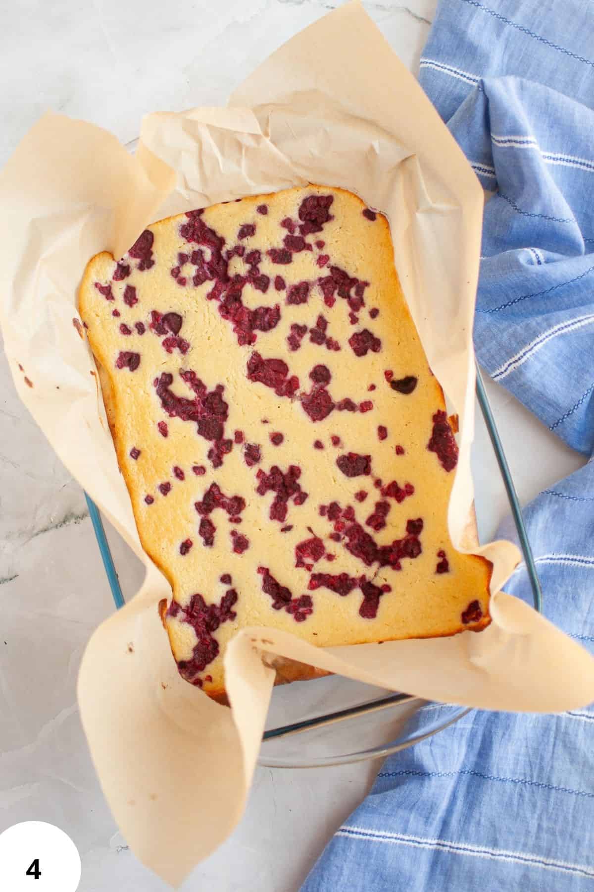 Berry cake in a baking pan with parchment paper, perfect for dessert or tea time.