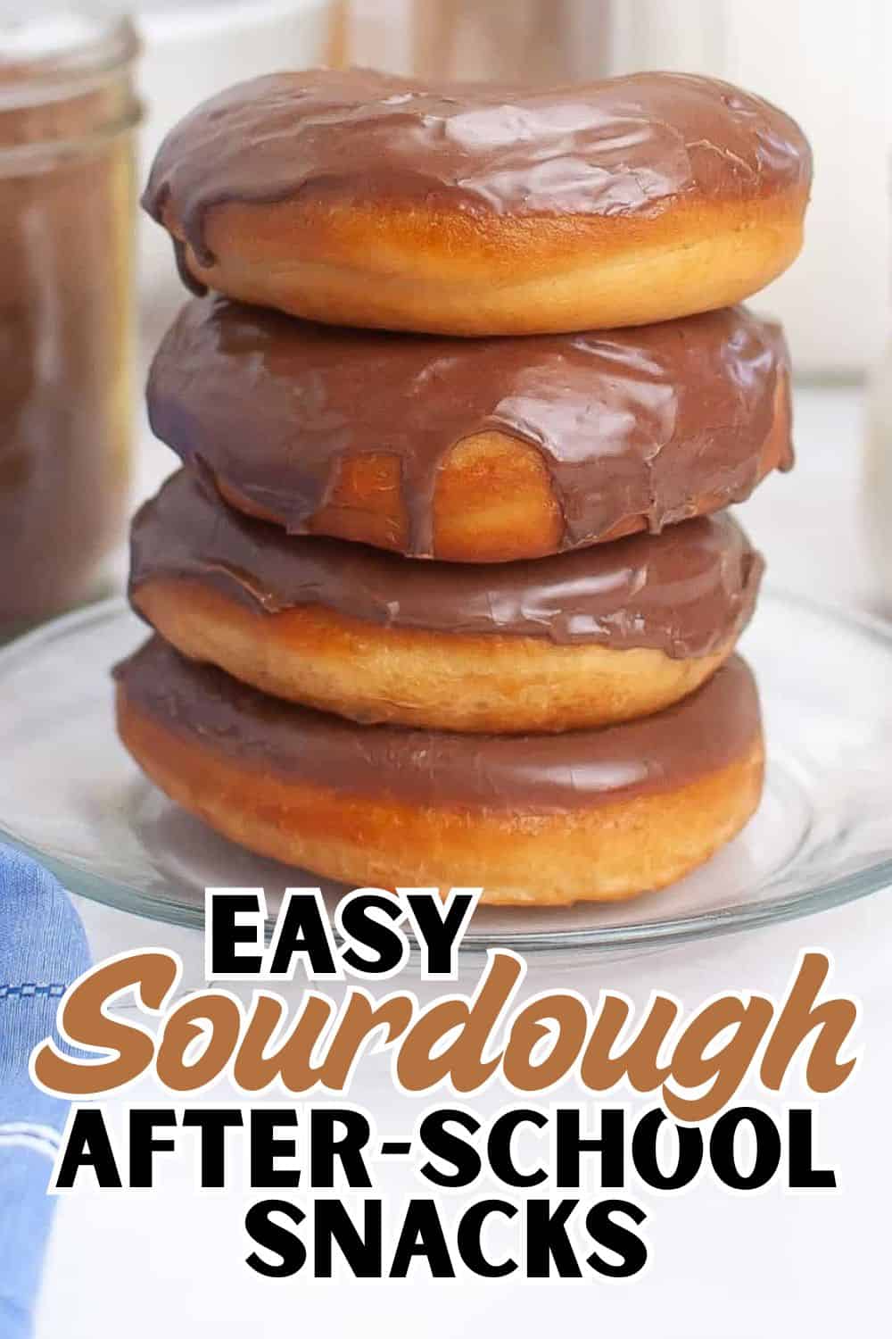 Delicious chocolate-glazed donuts stacked on a plate, perfect for after-school snacks.