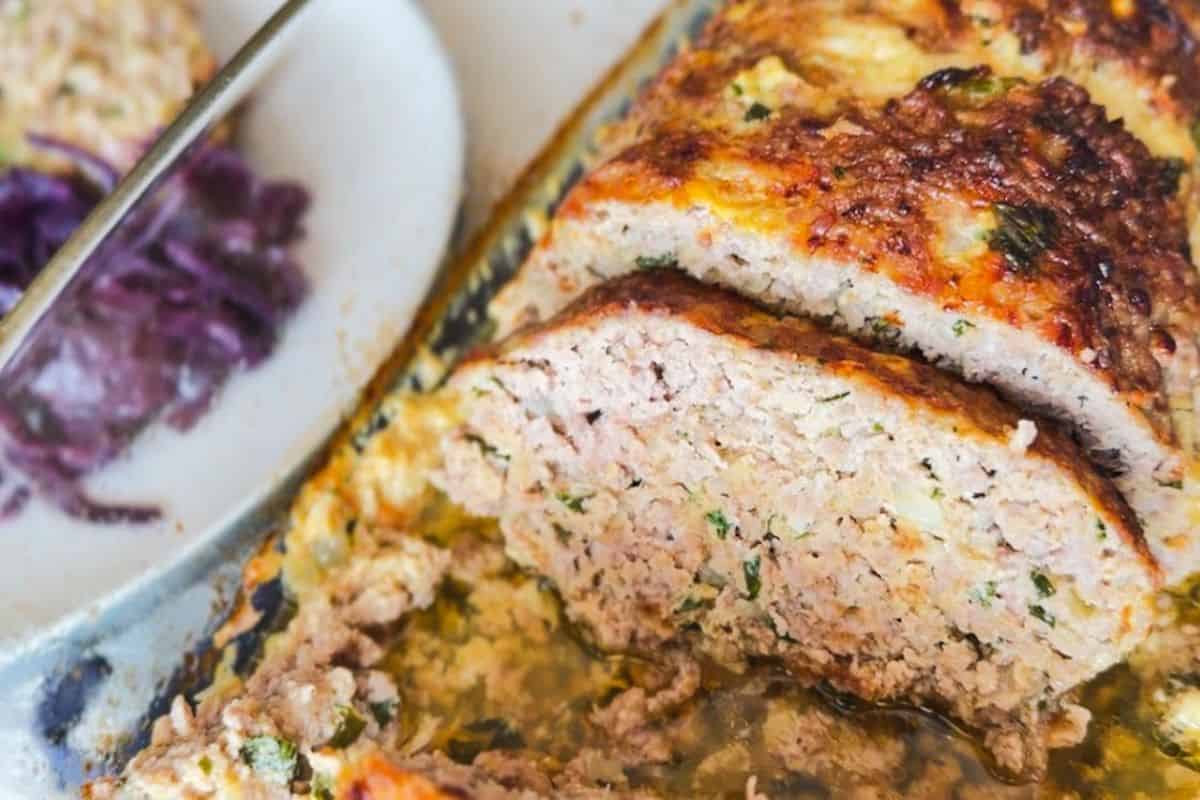 Close-up of a sliced German Hackbraten with a crispy crust and tender interior.