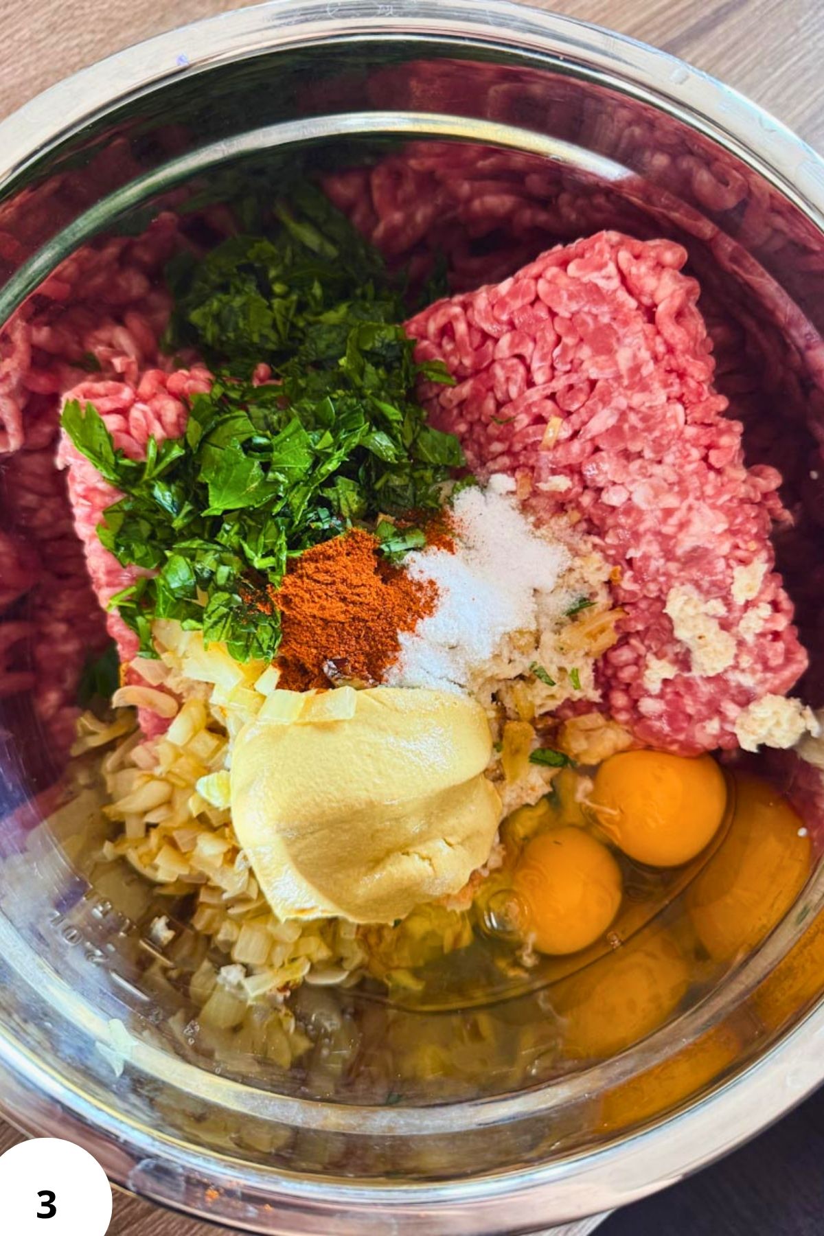Ground meat mixture with herbs, spices, and eggs for Hackbraten preparation.
