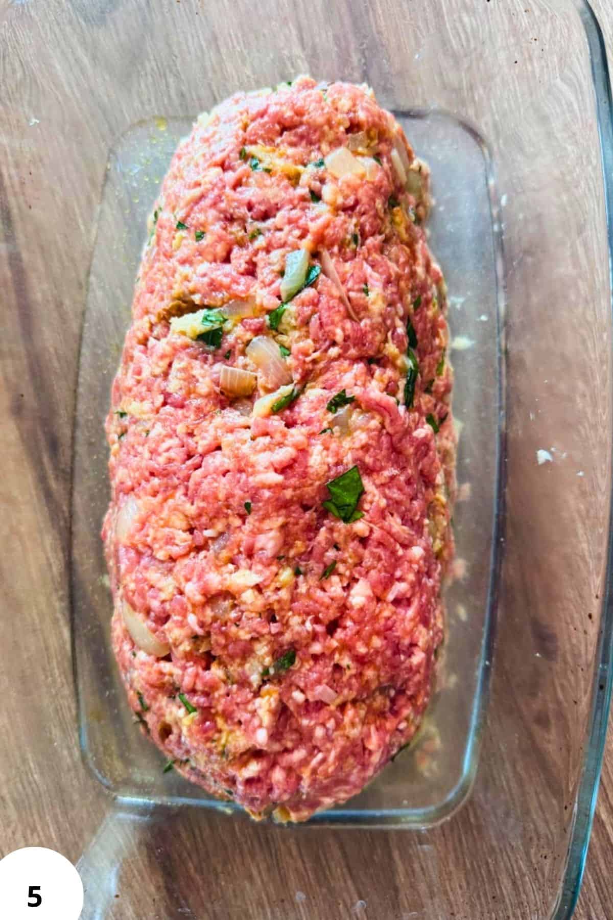 German Hackbraten meatloaf with herbs, vegetables, and spices for a flavorful dish.