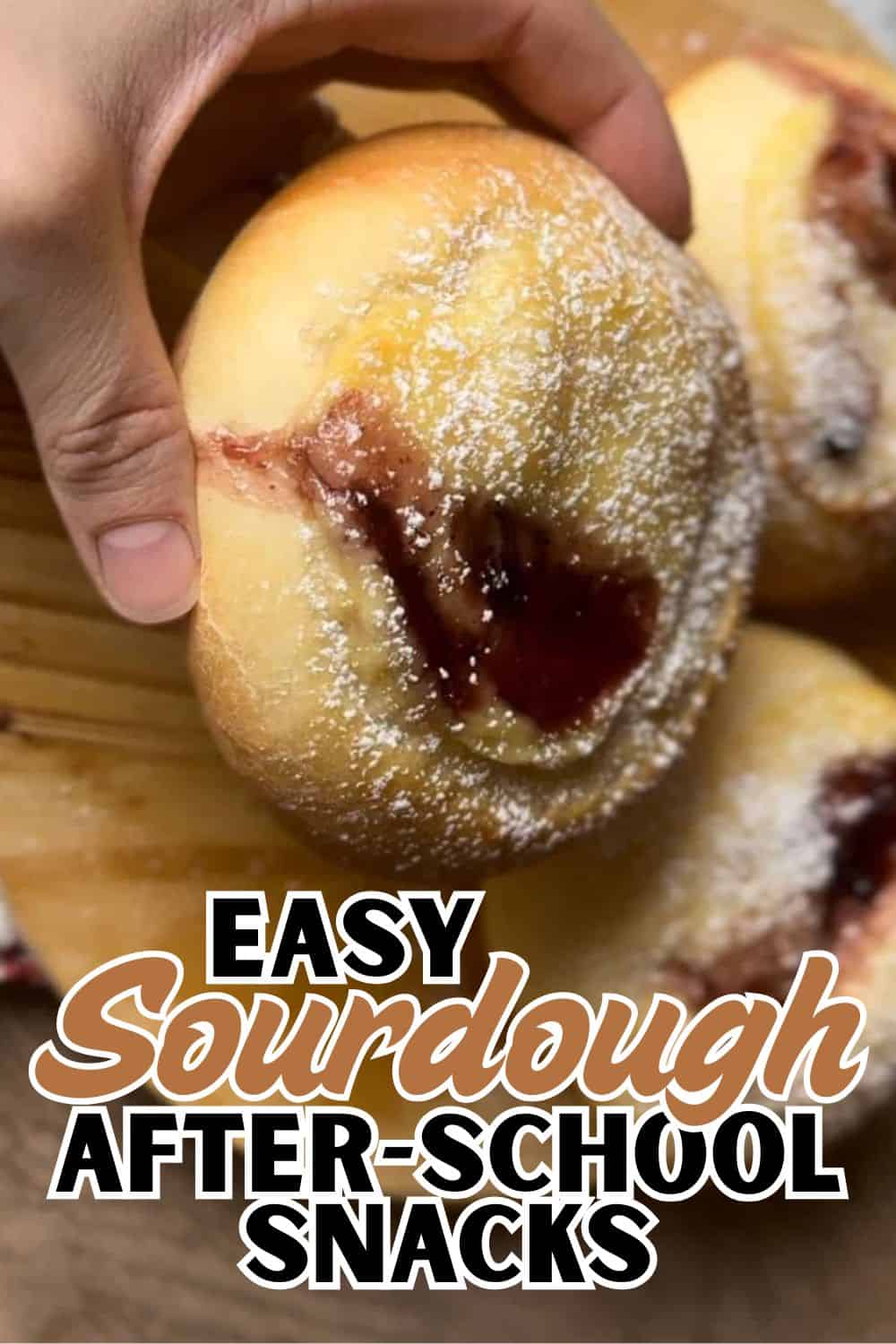 Fresh sourdough bread rolls with jam, dusted with flour, ready for snacks or breakfast.