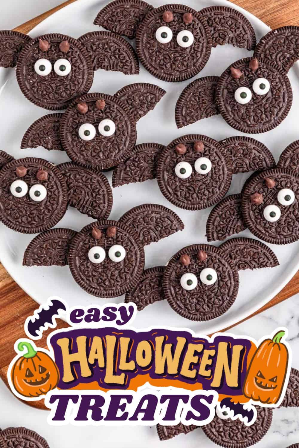 Cute Halloween bat-shaped Oreo cookies with eyes on a white plate.