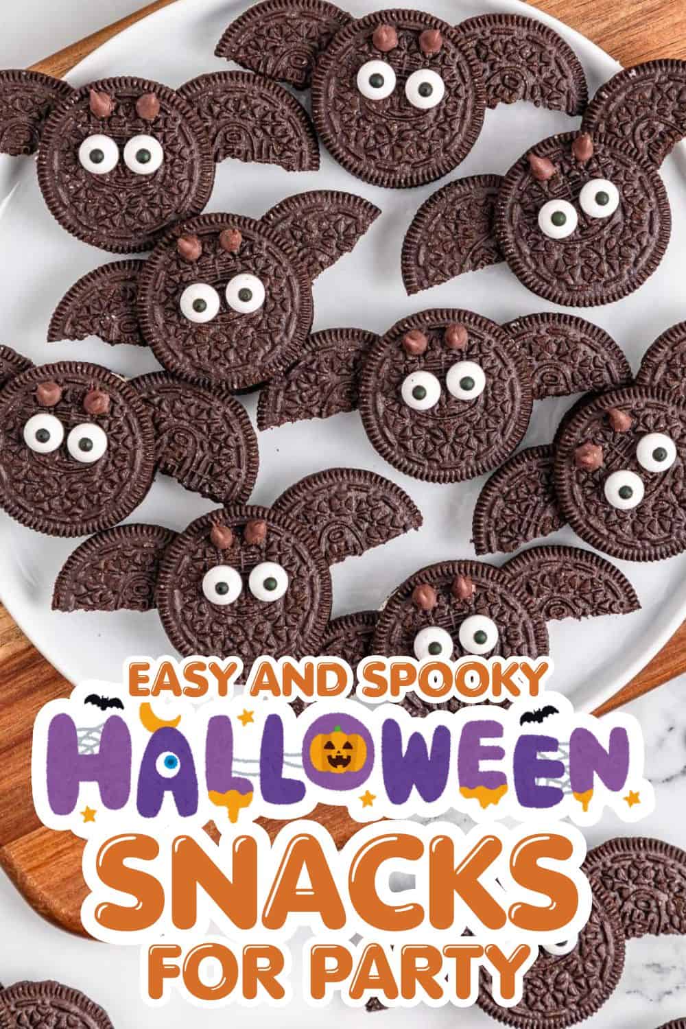 Oreo cookies decorated as spooky bats with candy eyes for Halloween treats.
