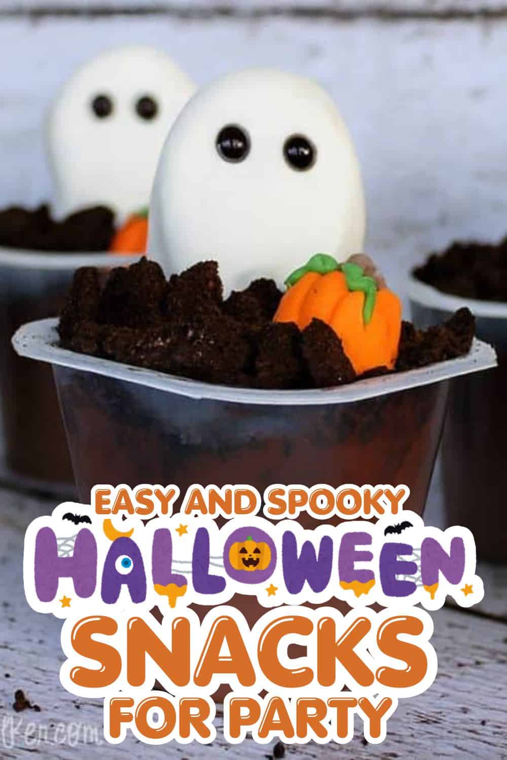 Halloween-themed ghost and pumpkin snacks with chocolate cake and decorative candies.
