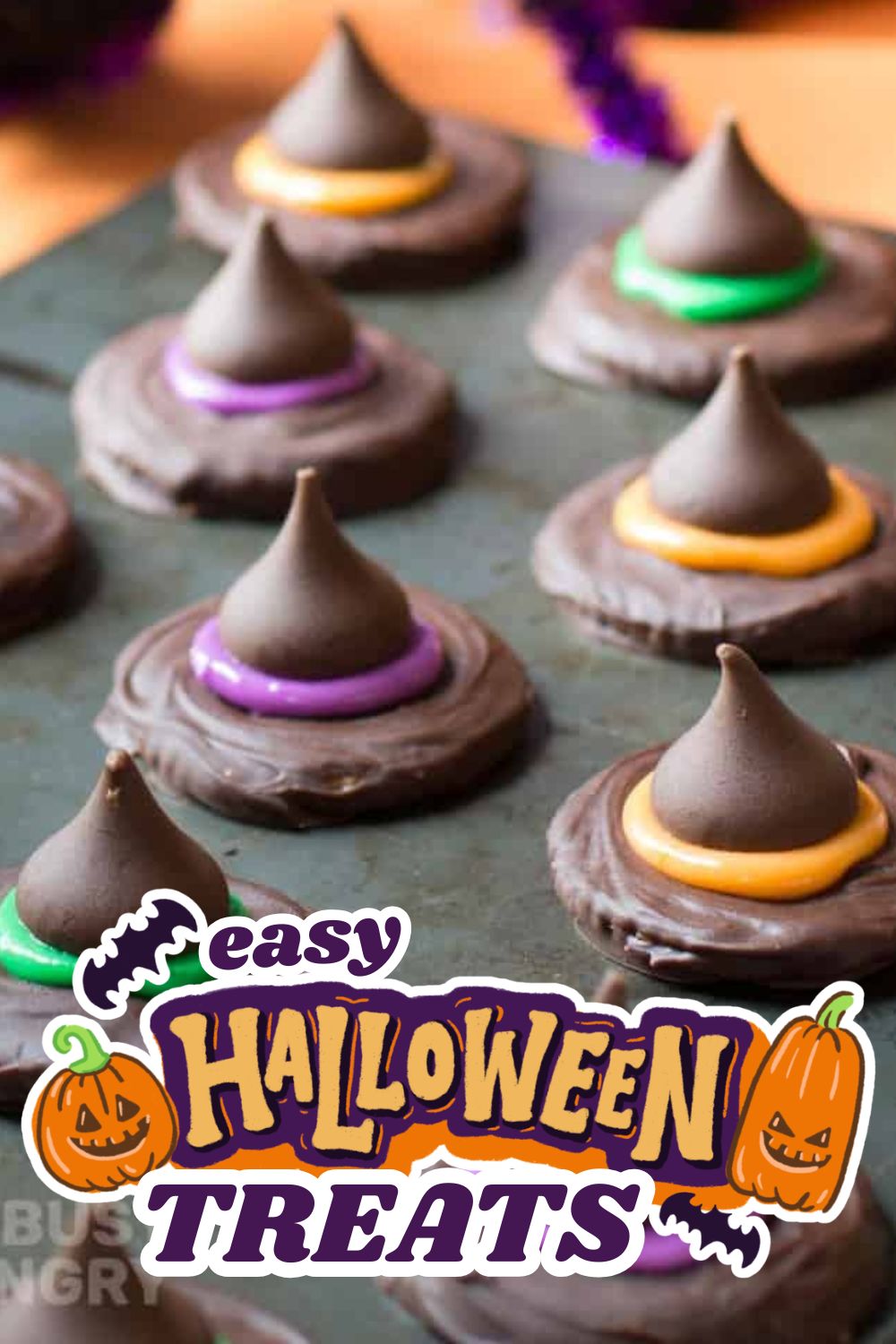 Chocolate cookies decorated as mummies with colorful icing for Halloween.