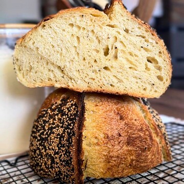 Close-up of sliced semolina sourdough bread with a golden crust.
