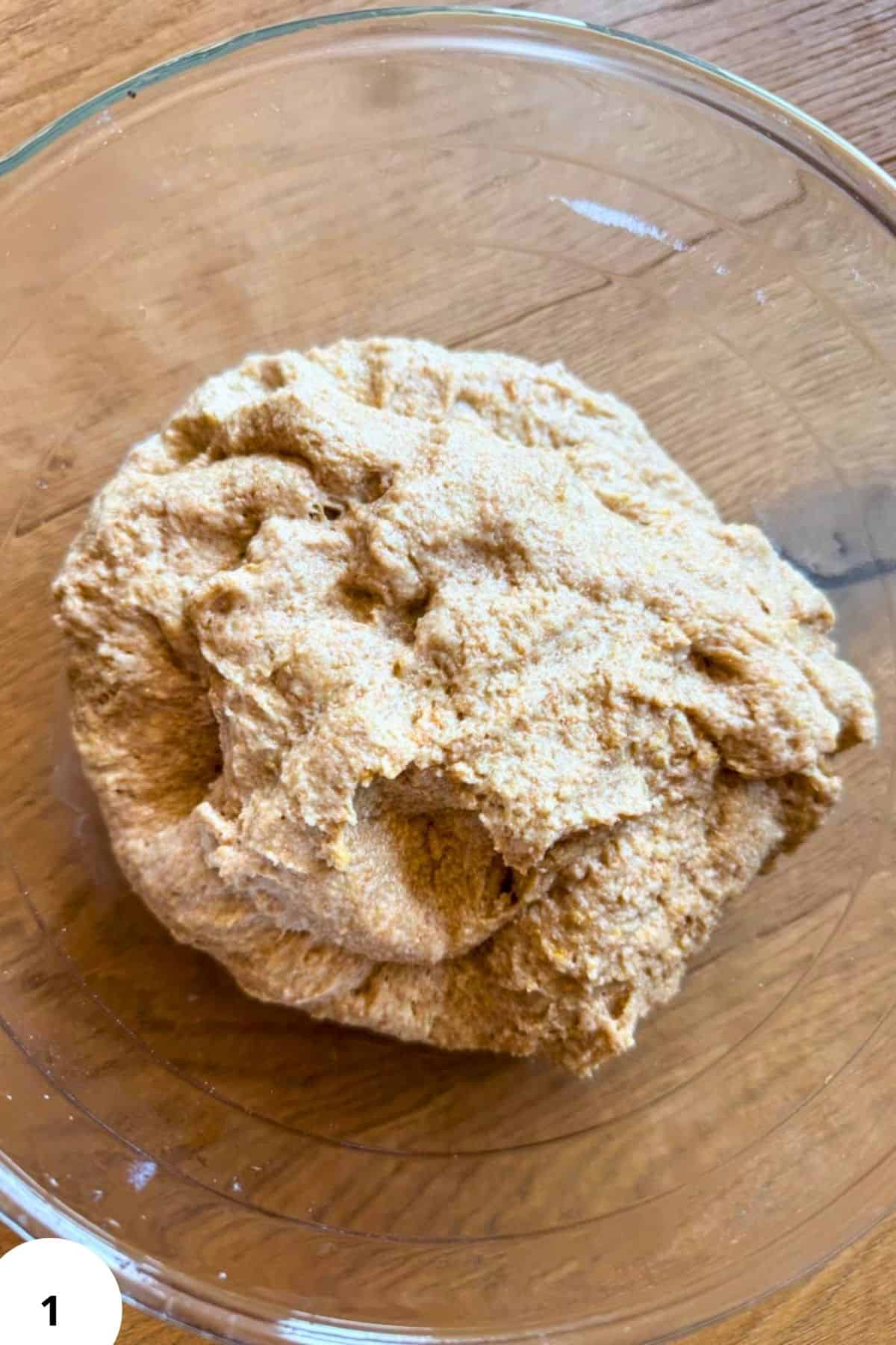 Freshly milled whole grain flour dough in a glass bowl for baking recipes.
