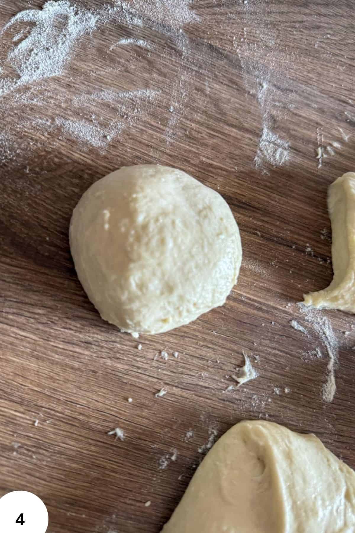 Dough ball prepared for stretching and folding process in bread baking.