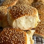 Freshly baked sesame seed buns with soft, fluffy interior and golden crust.