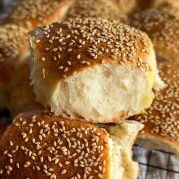 Freshly baked sesame seed buns with soft, fluffy interior and golden crust.