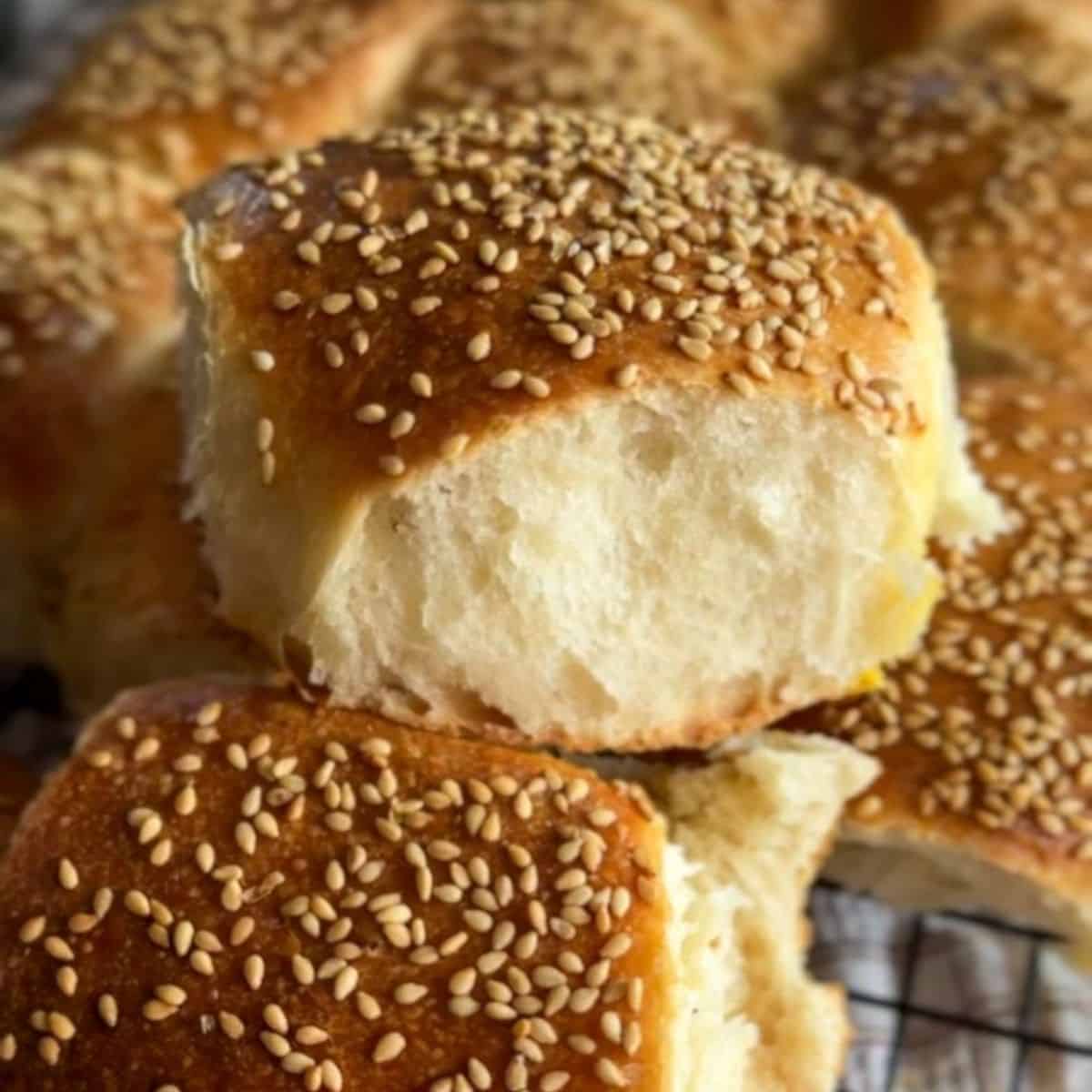 Freshly baked sesame seed buns with soft, fluffy interior and golden crust.