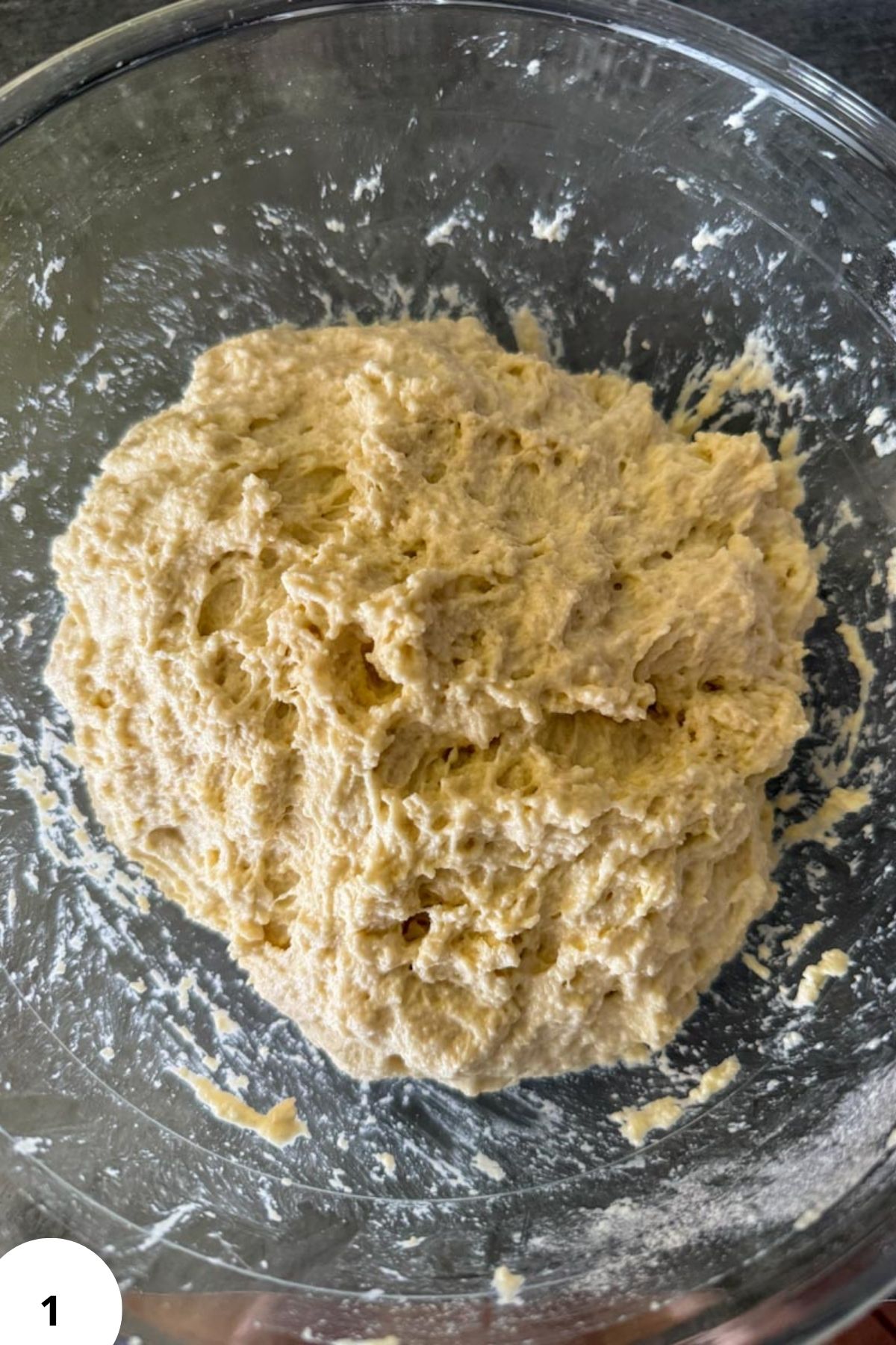 Sourdough pizza dough in a glass bowl ready for baking.