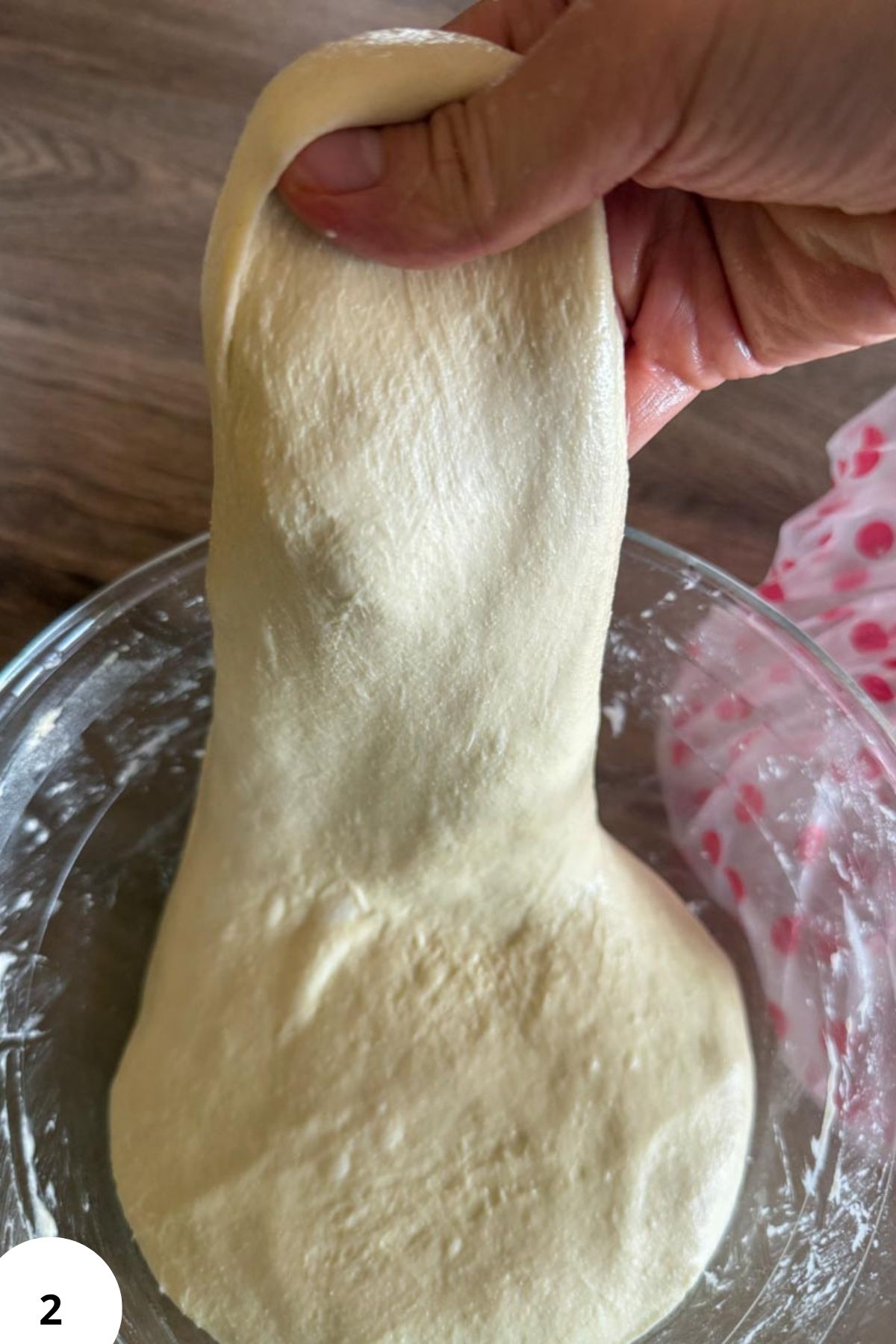 Stretch and fold technique for sourdough pizza dough preparation.