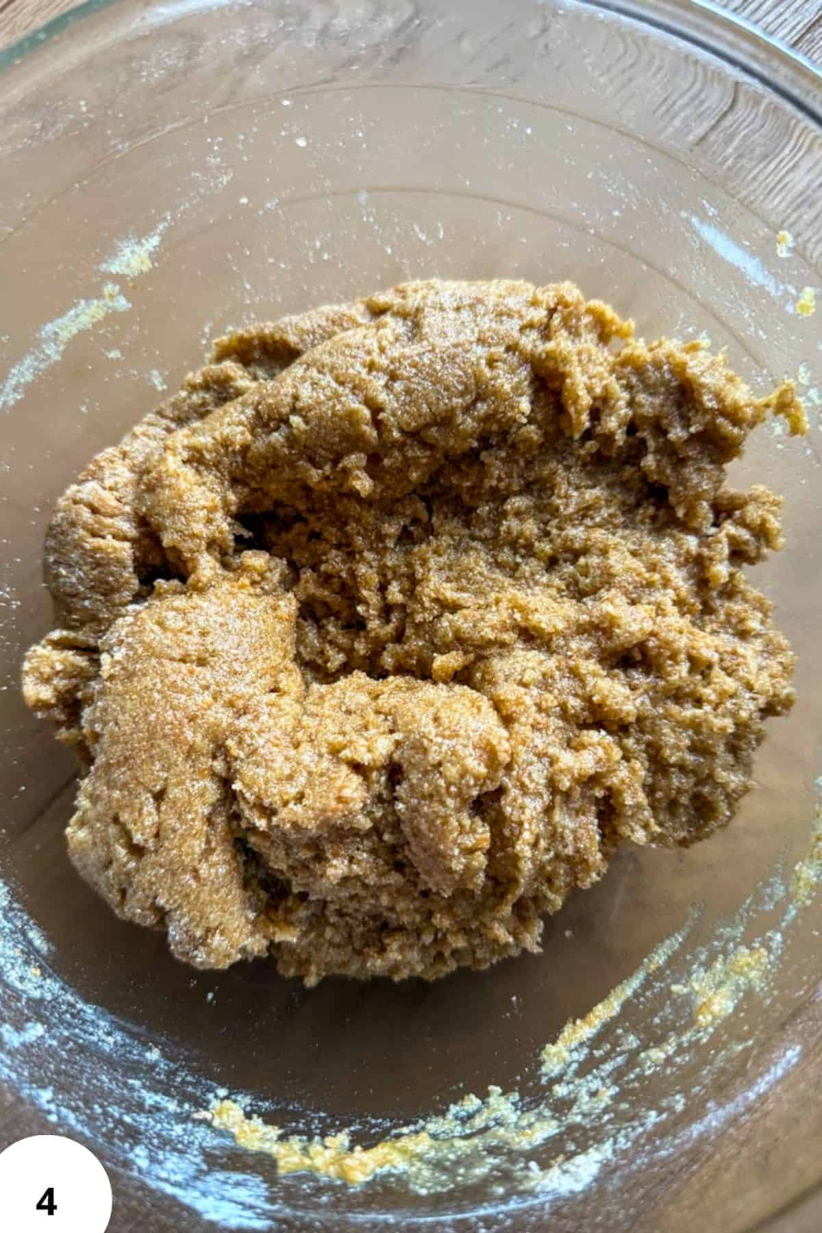 Cookie dough mixture in a glass bowl ready for baking.