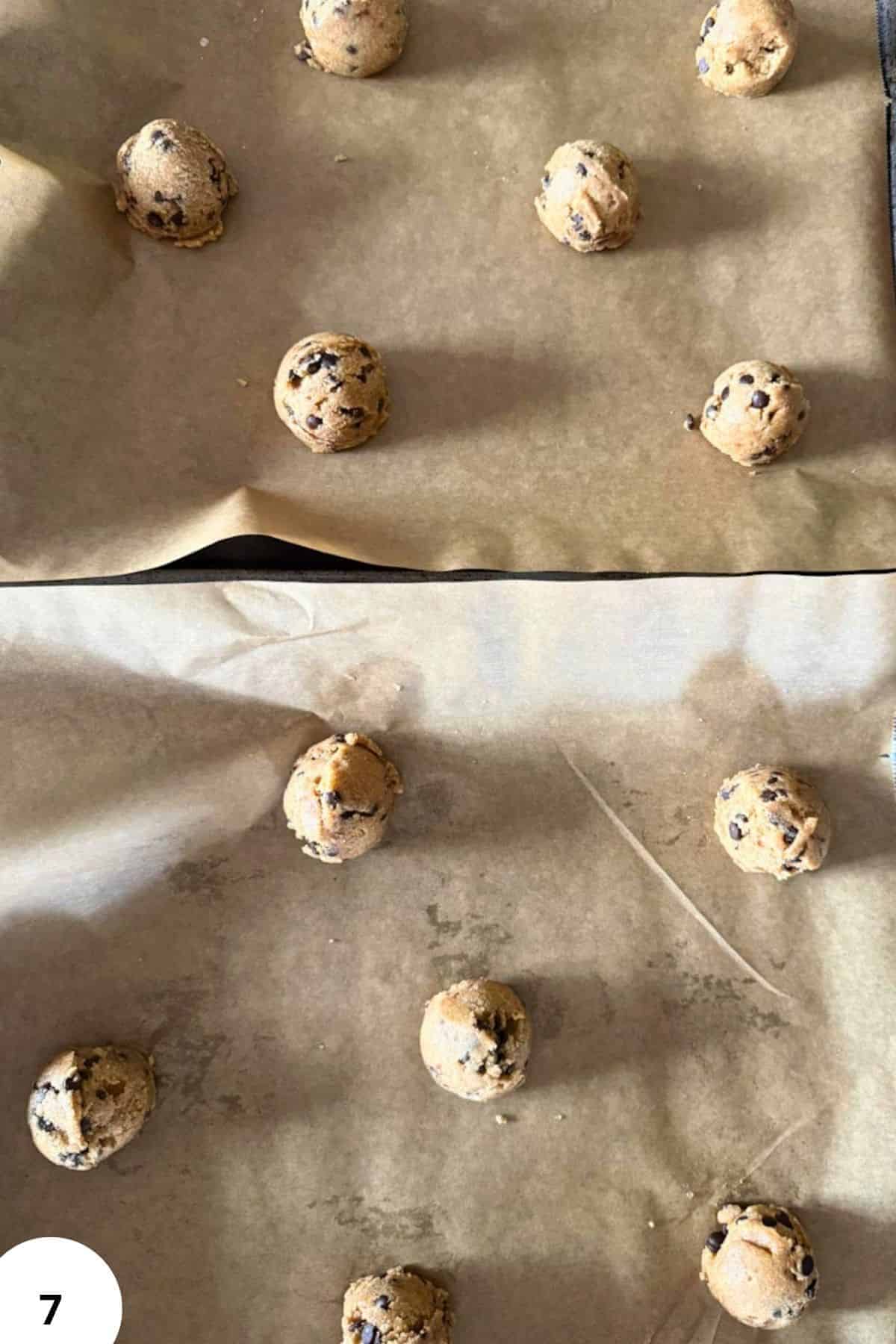 Raw cookie dough balls with chocolate chips on parchment paper.