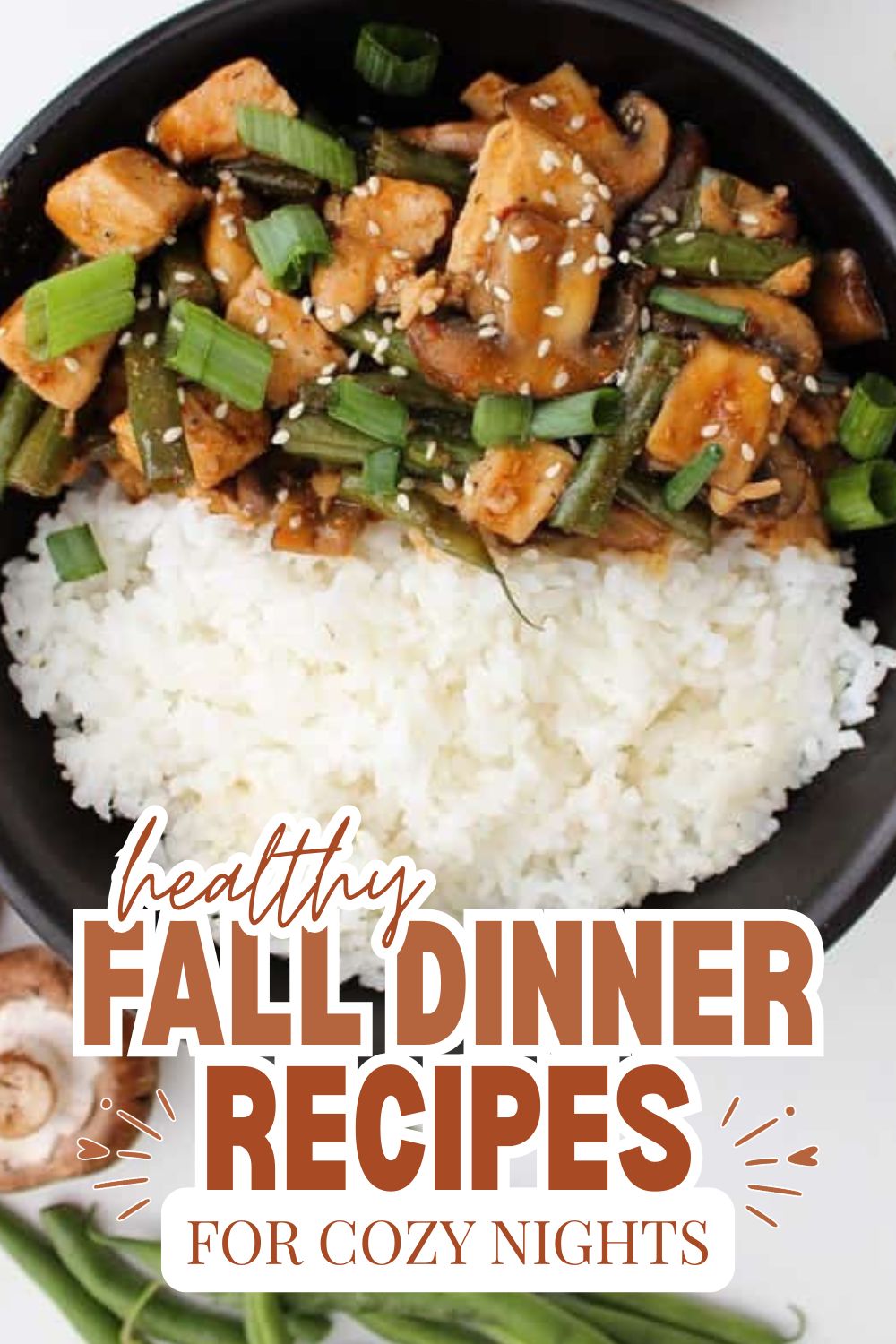 Healthy fall dinner with rice, vegetables, and chicken in a black bowl.