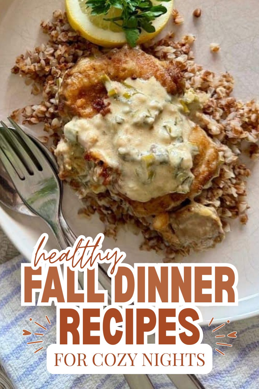 Baked chicken with creamy herb sauce served with rice and lemon wedge.